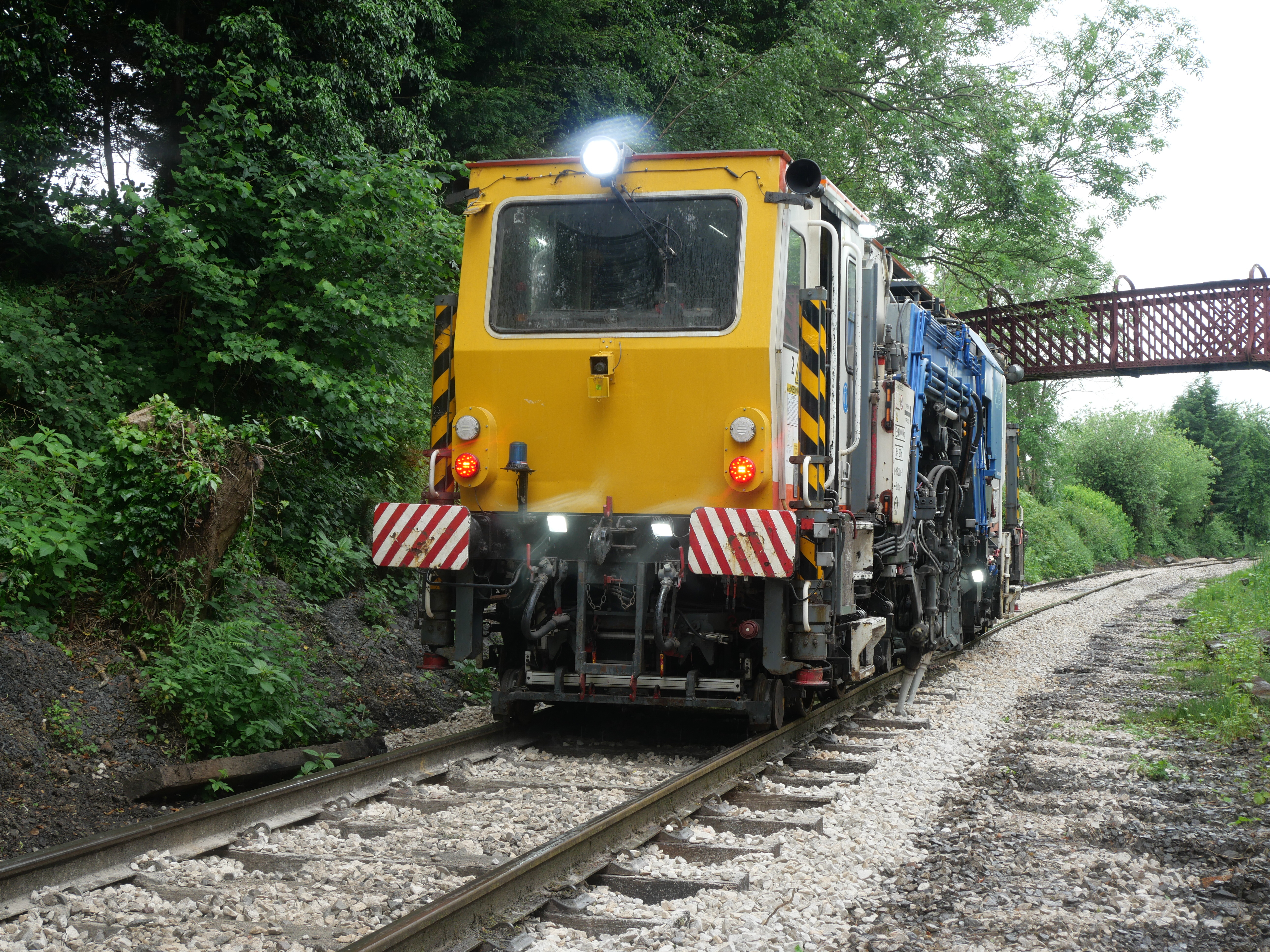 Beaver tamper tamping on the railway